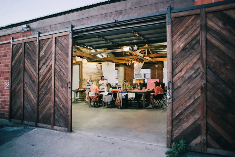 Brick + Laurel's timber barn doors slid open onto a workshop in progress at the long tables